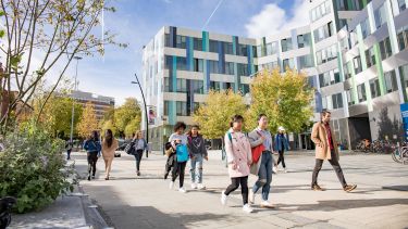 Staff and students walking on campus