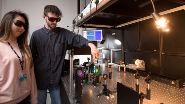 Chemistry postgraduate Liam Smith with a colleague in lab
