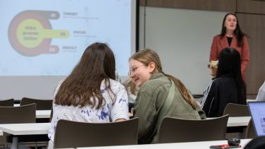 Two teenagers working in a classroom