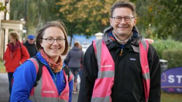 Two ParkRun volunteers in high vis jackets.